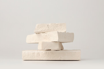 White stones platform podium on beige light copy spase background. Minimal empty display product presentation scene.