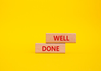 Well done symbol. Wooden blocks with words Well done. Beautiful yellow background. Business and Well done concept. Copy space.