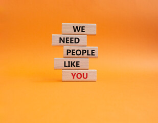 Hiring symbol. Wooden blocks with words We need People like You. Beautiful orange background. Business and Hiring concept. Copy space.