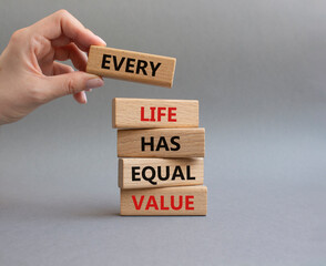 Equality symbol. Wooden blocks with words Every Life has Equal Value. Businessman hand. Beautiful grey background. Equality and life concept. Copy space.