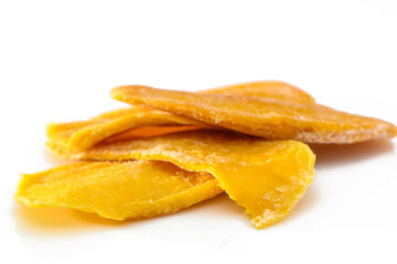 colorful pieces of dried mango fruit on a white background