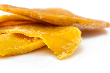 colorful pieces of dried mango fruit on a white background 1