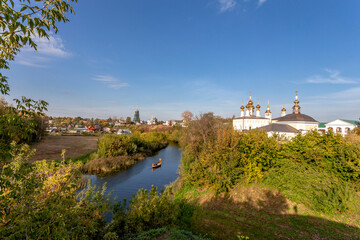 Suzdal, Vladimir region, Russia, Golden Ring - Panorama of the city. The bend of the river and all the famous churches of the city: the bell tower of the Ordinatorsky convent, Lazarevskaya, Assumption