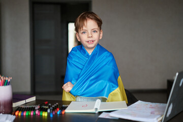Little boy smiling holding a yellow and blue flag Ukraine. Ukrainian child. Independence Day of...