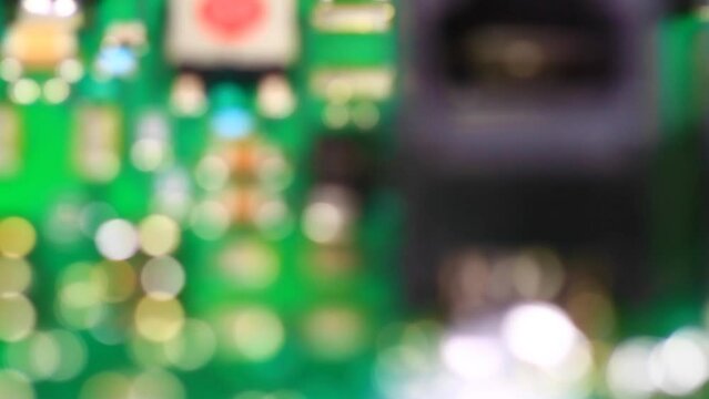Electronic circuit board with surface mounted components shown as soldered on the green printed circuit card. Focus in, Close up shot

