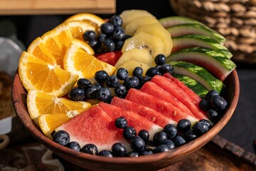 Bowl of fresh mixed fruit including watermelon, blueberries, oranges, and kiwi slices