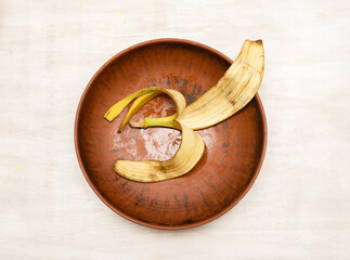Banana peel in a plate, top view.