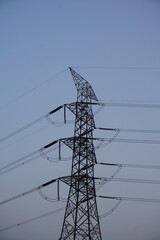 High voltage electricity transmission tower with the copy space, Electricity distribution pylon under the sky, Electricity transmission tower with blue sky background