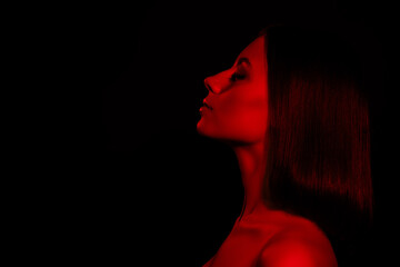 Photo of girl under red light neon profile side close eyes isolated dark color background
