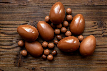 Chocolates background with chocolate eggs and sweets, top view