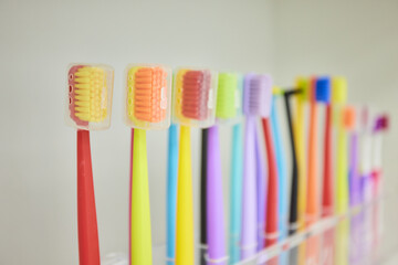 Colorful variety of toothbrushes neatly lined up in a row for maintaining oral hygiene