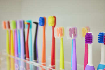 Colorful variety of toothbrushes neatly lined up in a row for maintaining oral hygiene