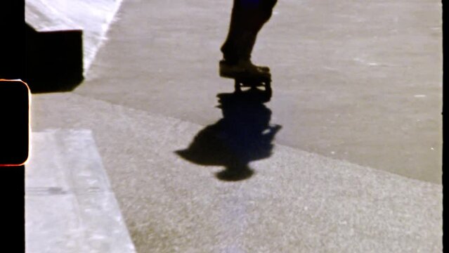 Man hipster in Paris rides his skateboard, perform skateboard tricks on sunny day shoot in film 8mm camera