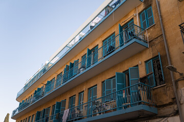 Fototapeta premium Cute and bohemian blue old balconies facade,wood windows in resident area of Nicosia