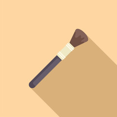 Professional makeup brush is lying on a beige background, casting a long shadow