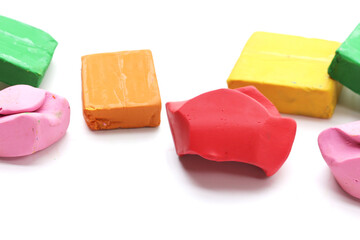 Colorful plasticine clay on white background.