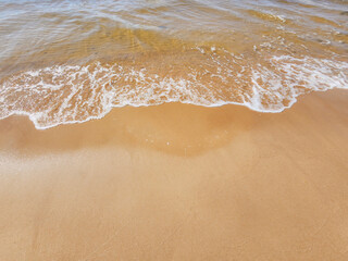 A tranquil beach scene with gentle waves lapping on a sandy shore, capturing the essence of peacefulness