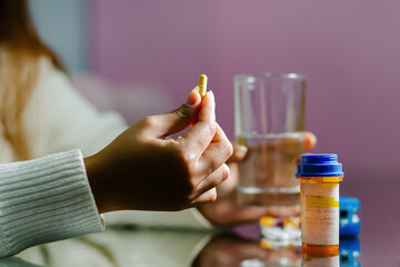 Woman Holding a Pill and Preparing to Take It.copyspace