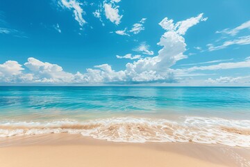 Fototapeta premium Serene beach with clear blue sky, gentle waves, and soft sandy shore.