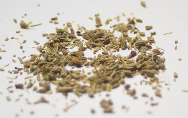 Scattered anise seeds, white background. Close up photo.