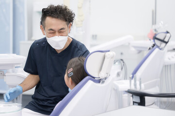 Doctor working at dentist and patient's child Image of pediatric dentistry Smiling dentist