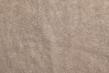 Soft brown towel as background, top view