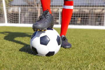 African American athlete training with soccer ball on a field