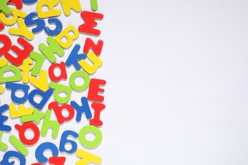 Alphabet. Many colorful magnetic letters isolated on white, top view