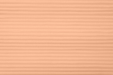 Fototapeta premium Peach fuzz color textured surface, closeup. Trendy shade of 2024 year