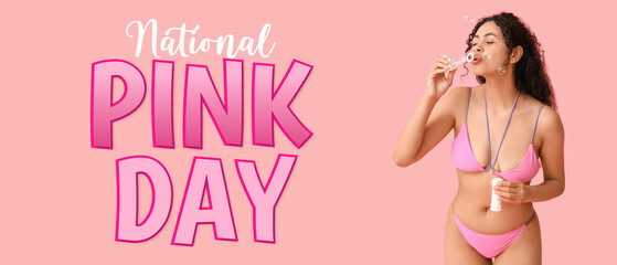 Beautiful young African-American woman in stylish swimsuit blowing soap bubbles on pink background