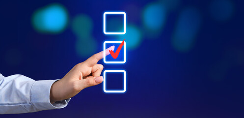 Young businesswoman using virtual screen on dark background