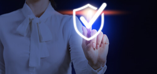 Young businesswoman using virtual screen on dark background