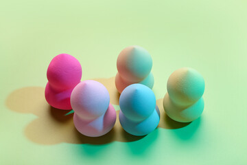 Different makeup sponges on green background