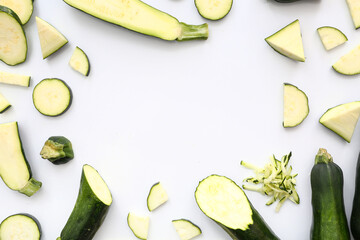 Frame made of fresh green zucchini on white background