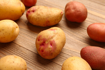 Fresh raw potatoes on wooden background