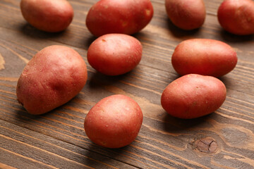 Fresh raw potatoes on wooden background