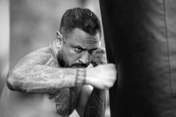 Naklejka premium Close up Portrait of muscular boxer. Man boxer face close up. Fists fight. Mans fight, punches. Kicks up. In the outdoor boxing arena. Man ready for boxings challenge. Man fight. Boxings fight. Boxing