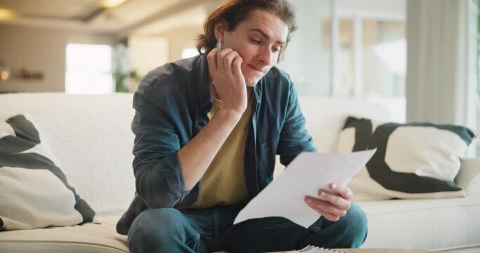 Stress, fear or man with paper on sofa for finance, budget or review, mistake or disaster at home. Education, documents and student with anxiety overwhelmed by loan rejection, inflation or crisis