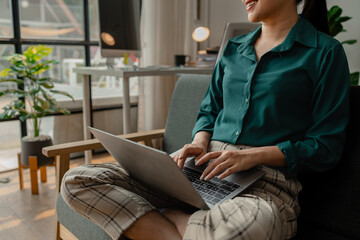 a businesswoman is using laptop in some area in workplace, she is meeting via video conference, a female employee is working in the office using laptop for typing some paperwork