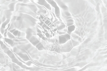 White water with ripples on the surface. Defocus blurred transparent white colored clear calm water surface texture with splashes and bubbles. Water waves with shining pattern texture background.