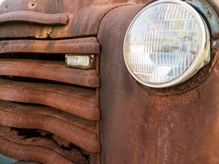 Rusted Old Car Front End With Rounded Headlight