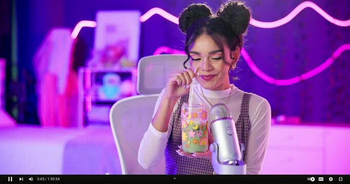 Woman, portrait and smile with drinking in room for testing on social media for juice cleanse with delicious. Influencer, streamer and microphone with online sensory relaxation content for stress.