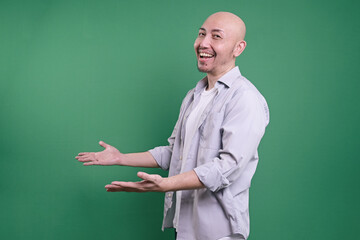 Side View Of A Smiling Bald Man With Open Arms Posing