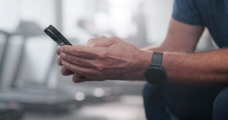 Smartwatch, hands and check time in gym for schedule, app and break after exercise. Smartphone, person and typing on device at fitness club for workout routine, goals and streaming training video