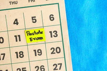 Prostate exam or cancer screening schedule for men concept. Written reminder note on calendar.