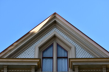 Victorian house, pointed window on second story.