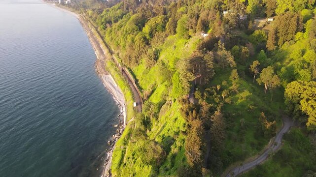 drone shoot of Black sea Batumi coast beautiful nature railway mountains nature side of Batumi beach sunset
