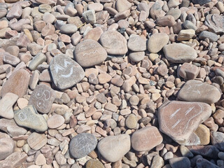 
Various facial expressions drawn on pebbles