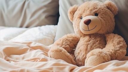 Cute toy bear sitting on bed