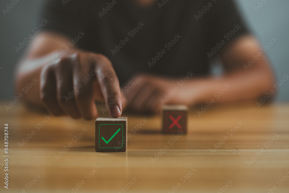 Poster businessman's hand chooses the one wooden cube block with the green right for approve and reject bus
